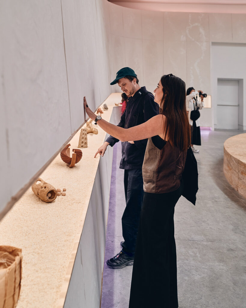 Visitors touch walls at the HOME as Country, Australia Pavilion, Venice Biennale 2025